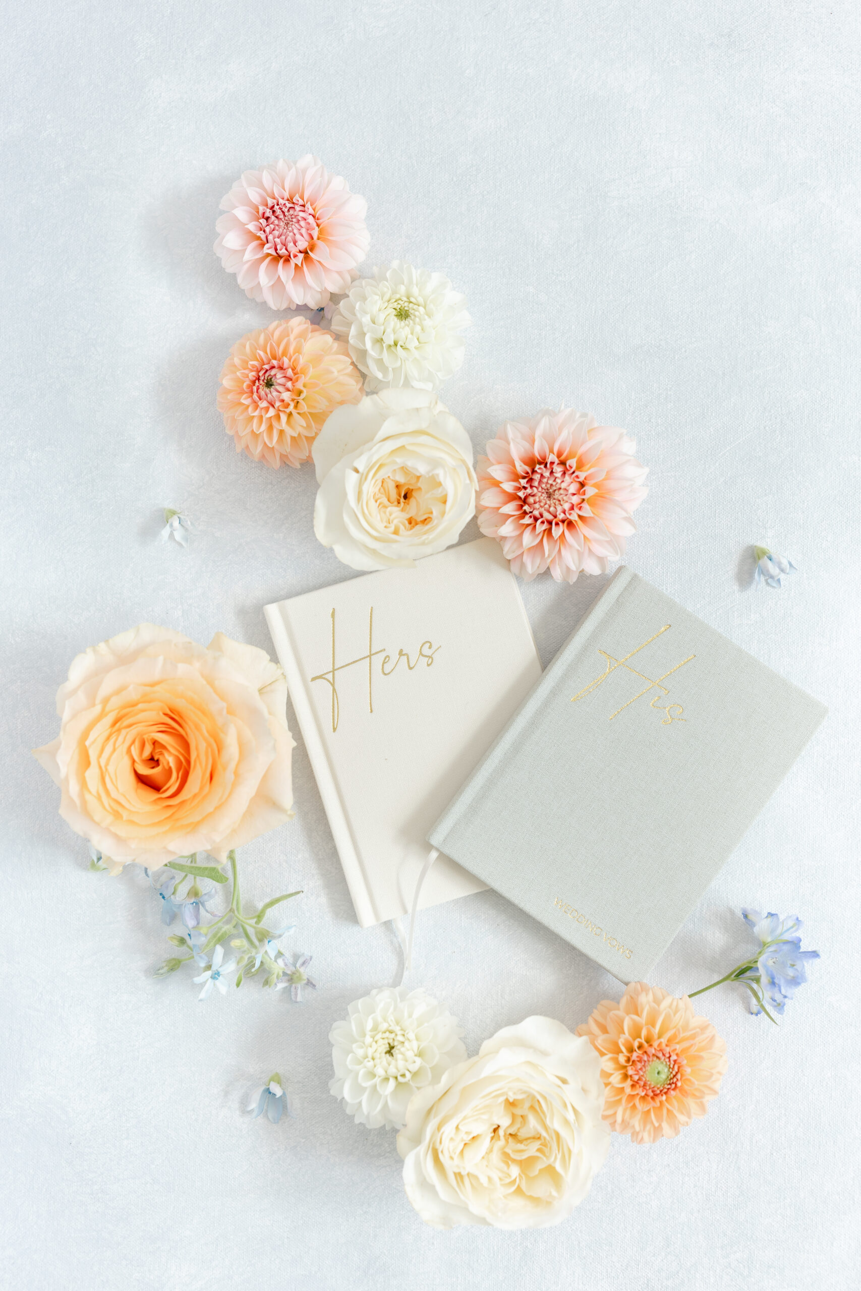 Flatlay of wedding invitation and photos illustrating the difference between documentary and editorial wedding photography.